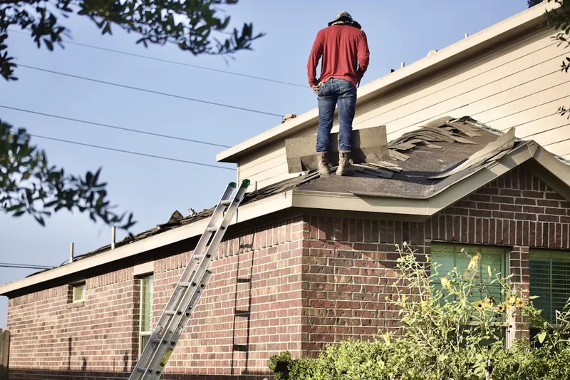 Professional roofer working on a residential roof in Boulevard Heights